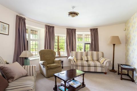 Moderne stue med stribede sofaer og syrin gardiner
